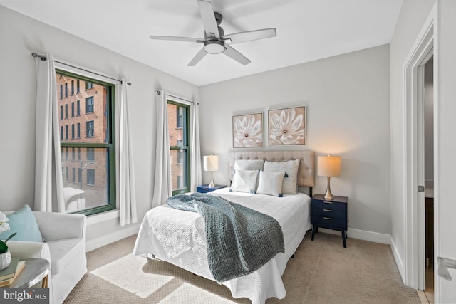 bedroom featuring ceiling fan and light colored carpet