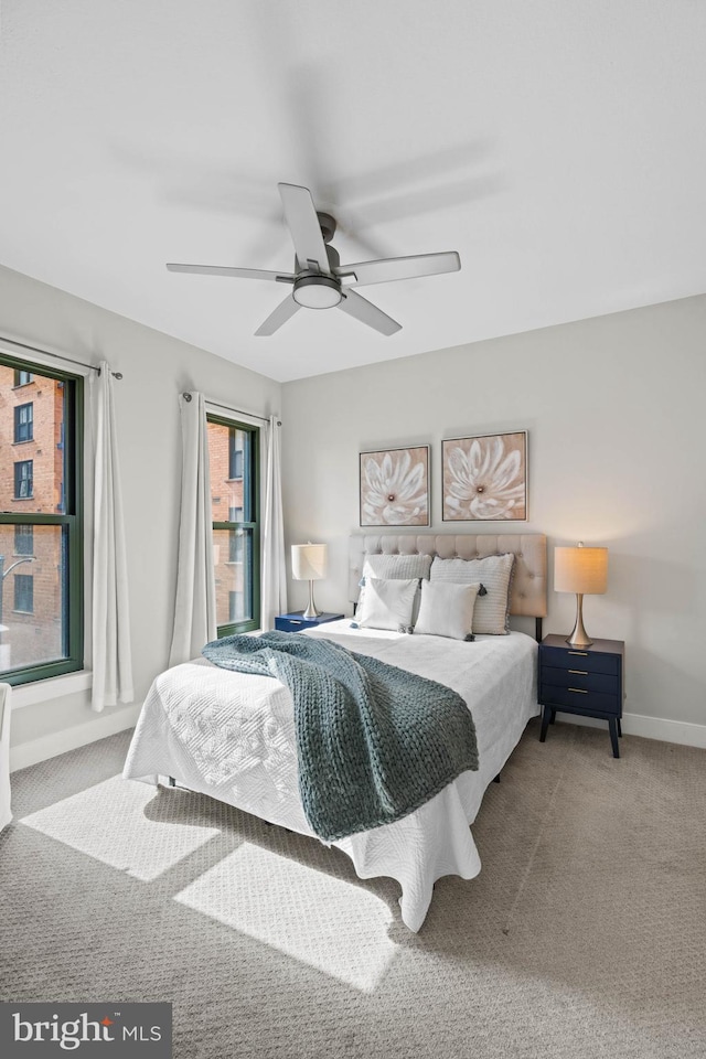 bedroom with ceiling fan and carpet floors