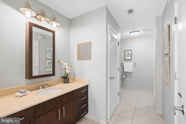 bathroom with tile patterned floors and vanity