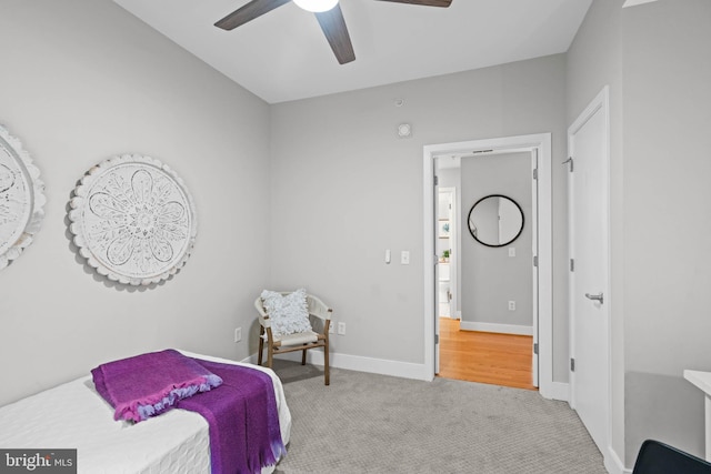 bedroom with ceiling fan and light carpet