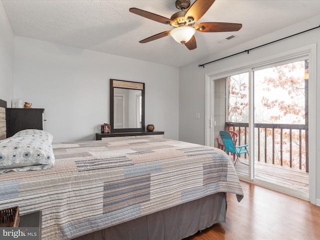 bedroom with access to outside, a textured ceiling, light hardwood / wood-style flooring, and ceiling fan