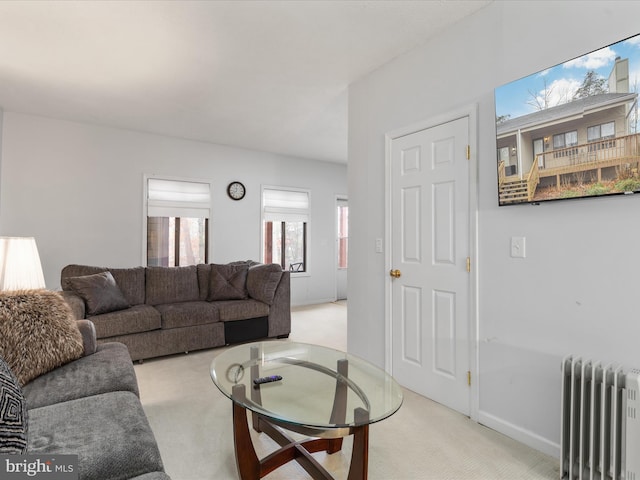 carpeted living room featuring radiator heating unit