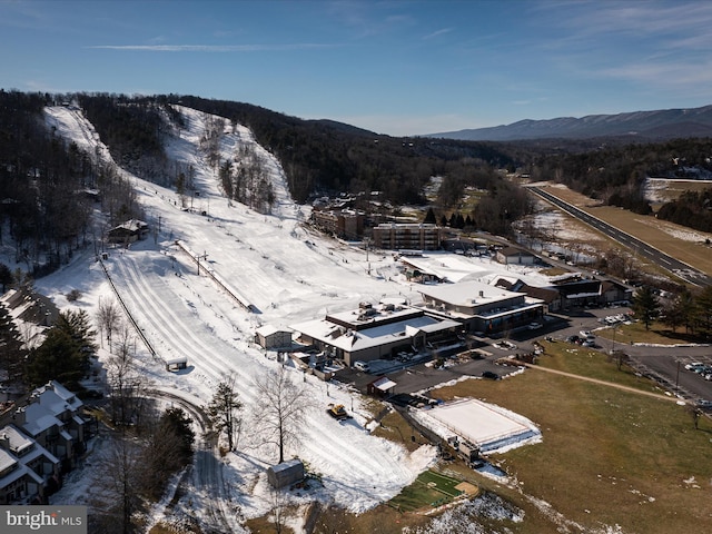 snowy aerial view featuring a mountain view