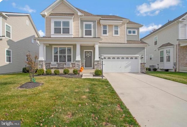 view of front of house featuring a front yard, a porch, and a garage