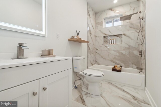 full bathroom with vanity, tiled shower / bath combo, and toilet