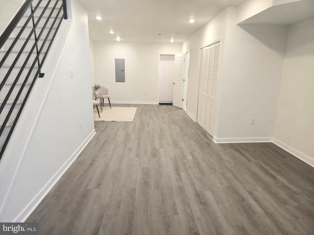 hall with electric panel and hardwood / wood-style flooring