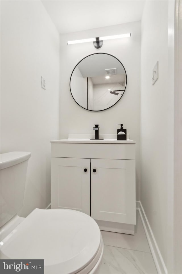 bathroom with vanity and toilet