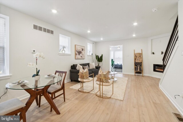 living room with light wood-type flooring and a healthy amount of sunlight