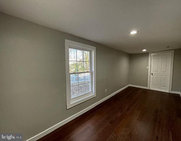 spare room with dark hardwood / wood-style floors