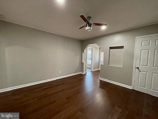 empty room featuring dark hardwood / wood-style flooring and ceiling fan