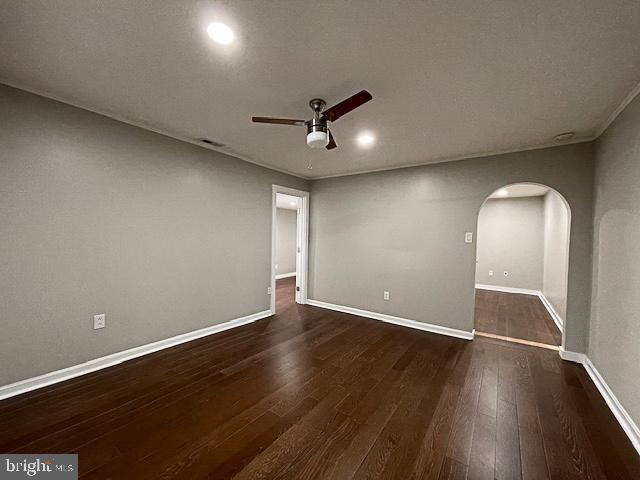 unfurnished room with ceiling fan and dark hardwood / wood-style floors