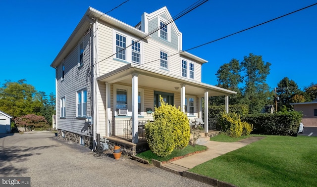 view of front of house featuring a porch and a front lawn