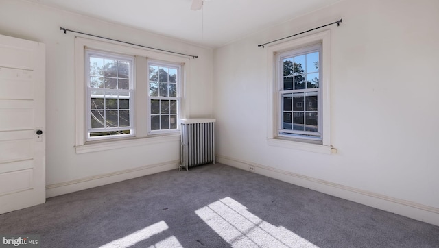 empty room with radiator heating unit and carpet