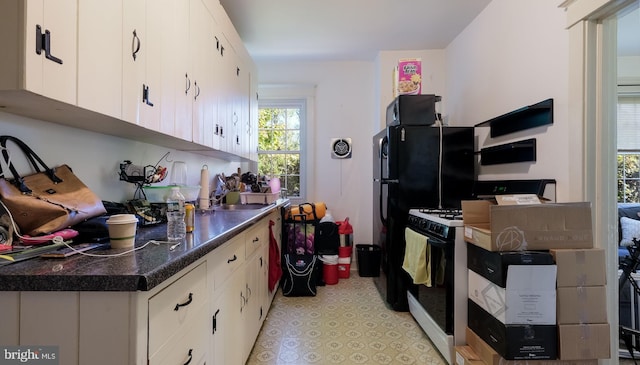 kitchen with white cabinets and white gas stove