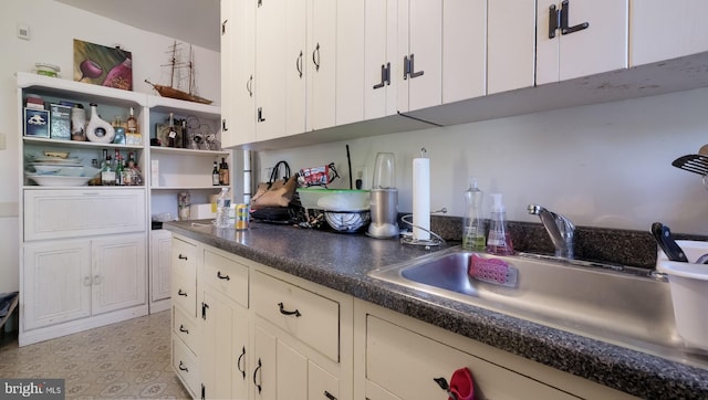 kitchen with white cabinetry and sink