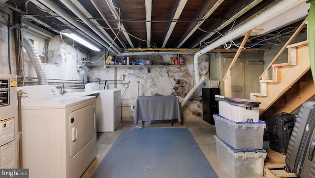 basement featuring washer and clothes dryer and water heater