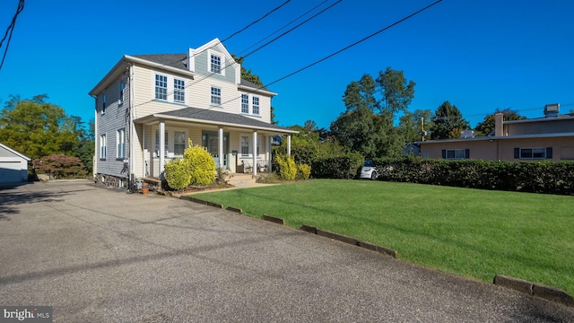 view of front of house featuring a front lawn and a porch