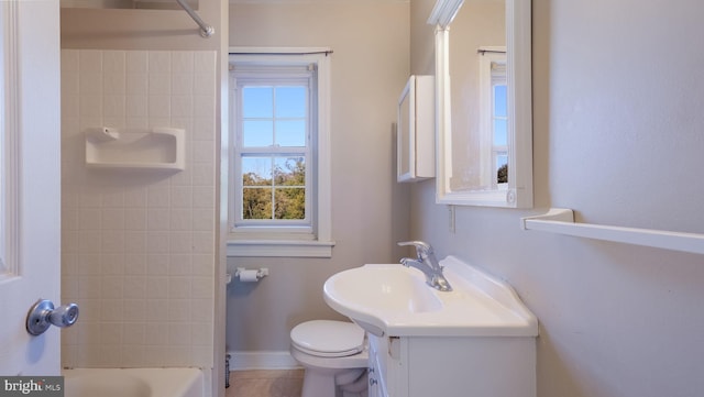 full bathroom with toilet, vanity, tiled shower / bath, and tile patterned floors