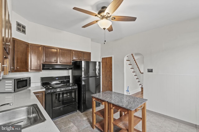 kitchen with ceiling fan, dark brown cabinets, sink, and black appliances