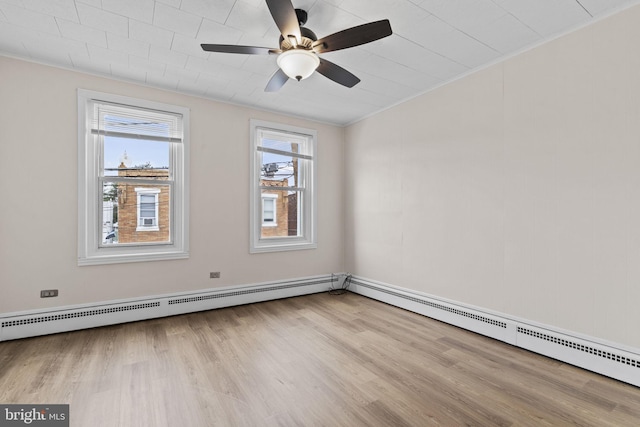 empty room with a baseboard radiator, ornamental molding, ceiling fan, and light hardwood / wood-style floors