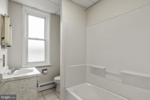 full bathroom featuring a drop ceiling, tile patterned flooring, vanity, and a baseboard heating unit