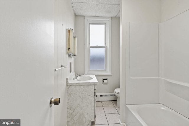 bathroom featuring a paneled ceiling, vanity, toilet, tile patterned floors, and baseboard heating