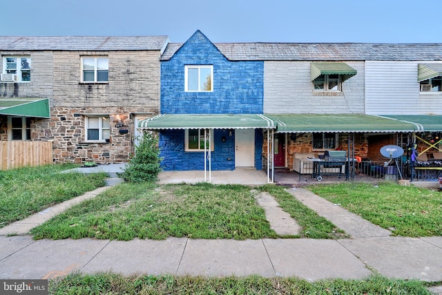 view of property featuring a front yard