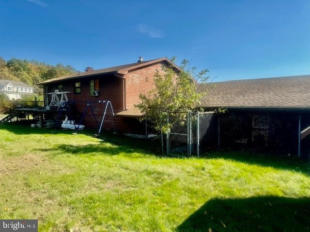 rear view of house featuring a lawn