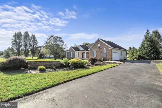 ranch-style house with a garage and a front yard