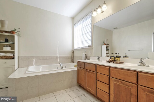 bathroom with vanity, a relaxing tiled tub, and tile patterned floors