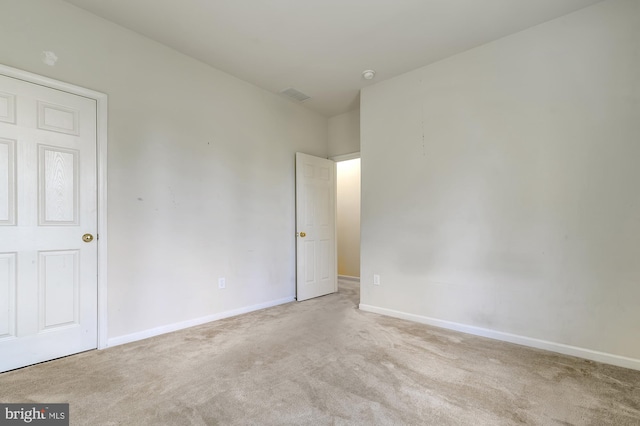 empty room with light colored carpet