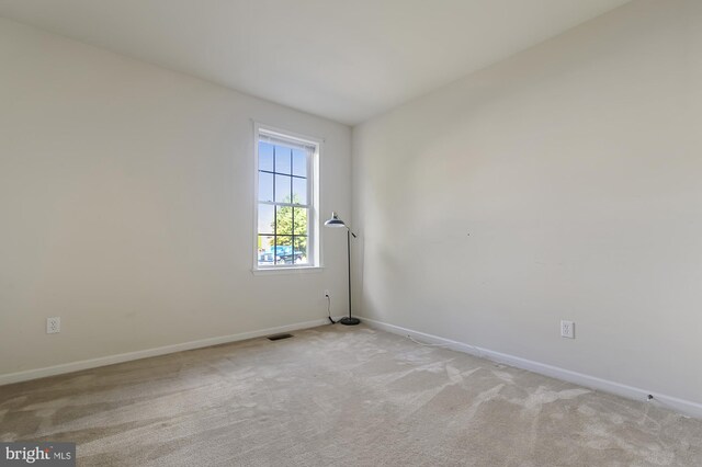 unfurnished room with light carpet