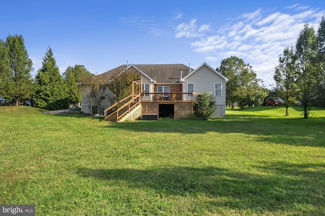 rear view of house featuring a yard and a deck