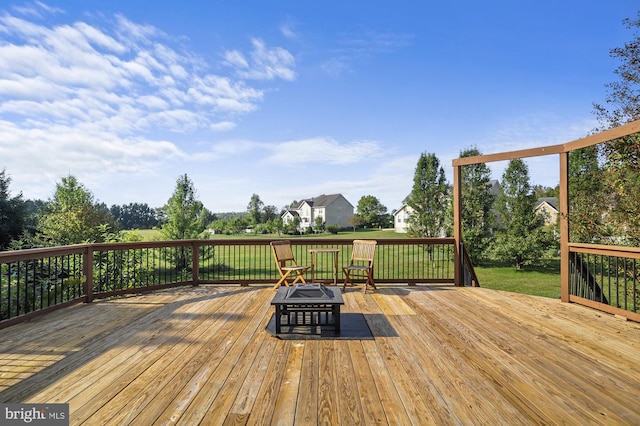 deck with a yard and an outdoor fire pit