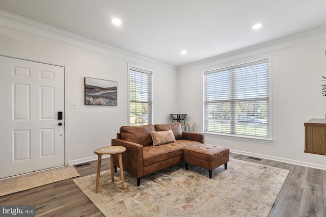 living room with hardwood / wood-style flooring and ornamental molding