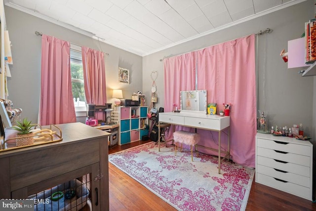 bedroom featuring crown molding and dark wood-type flooring