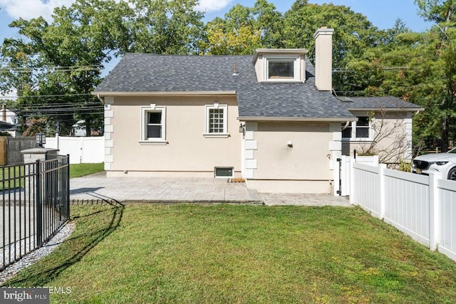 back of house featuring a yard and a patio area