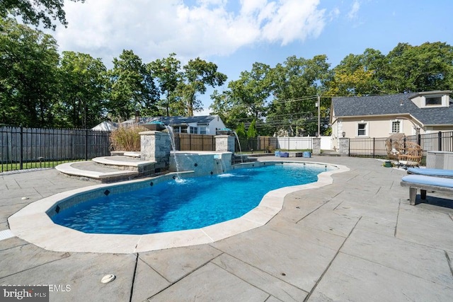 view of swimming pool with a patio and pool water feature