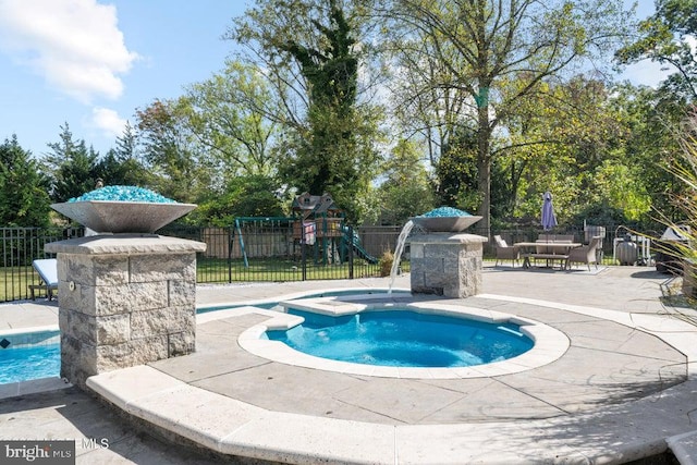 view of swimming pool featuring an in ground hot tub and a patio