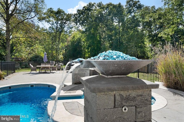 view of swimming pool featuring a patio area