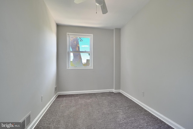 unfurnished room featuring ceiling fan and dark colored carpet