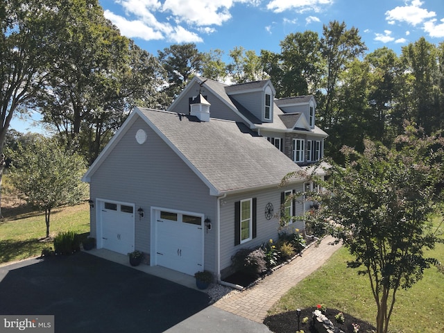 view of property exterior with a yard and a garage