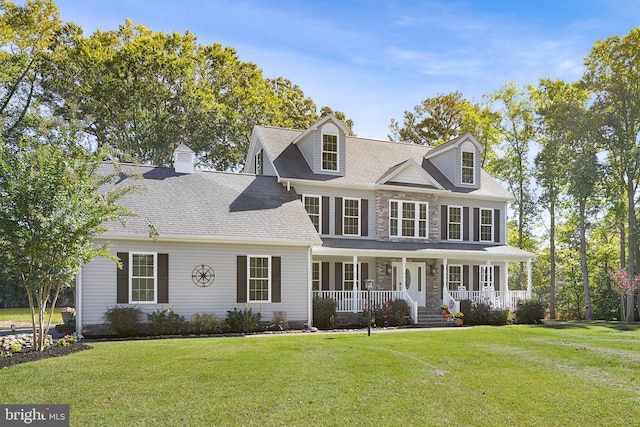 view of front facade with a front lawn and covered porch