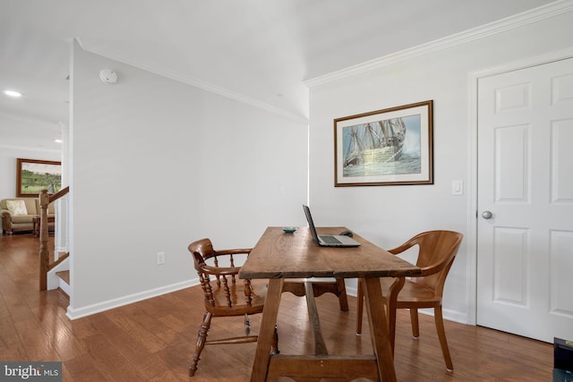 dining area featuring crown molding and hardwood / wood-style flooring