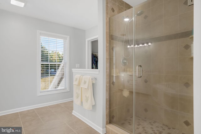 bathroom featuring tile patterned flooring and an enclosed shower