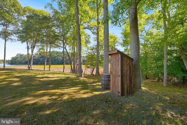 view of yard with a water view and a storage shed