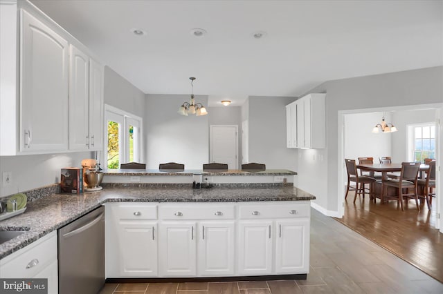 kitchen featuring a chandelier, dark wood-type flooring, dishwasher, kitchen peninsula, and white cabinets