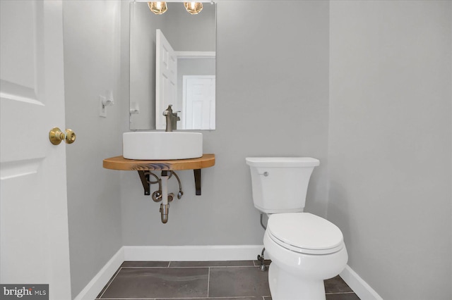 bathroom with tile patterned floors, sink, and toilet