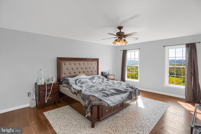 bedroom featuring ceiling fan and dark hardwood / wood-style flooring