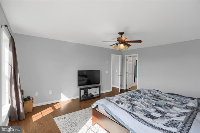 bedroom with ceiling fan and dark hardwood / wood-style floors